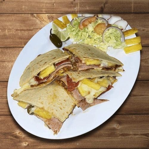 Hawaiian quesadilla with cheese, ham, and pineapple in a flour tortilla in Kennewick, WA. Hawaiian quesadilla with cheese, ham, and pineapple in a flour tortilla in Kennewick, WA.