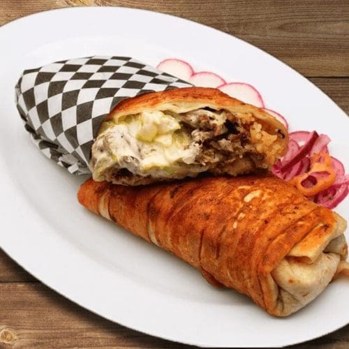 Burrito filled with crispy bacon, cheese, rice, and beans in Kennewick, WA.
